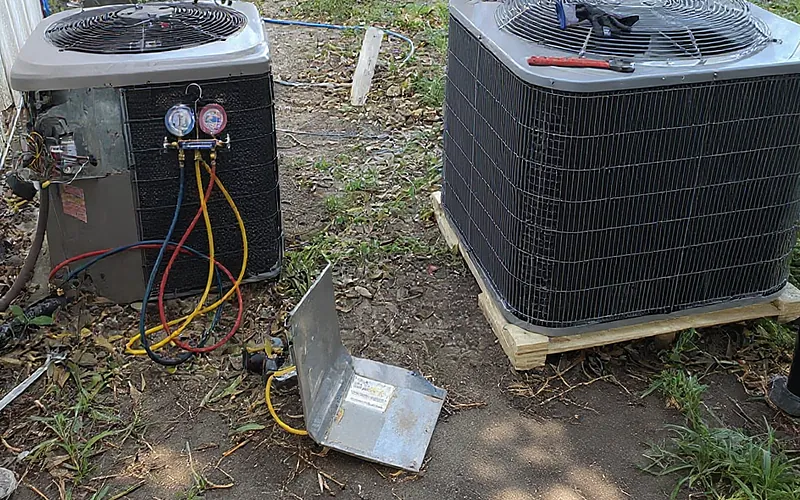 Old and new outdoor AC condenser units side by side during a Sanmor HVAC Solutions system replacement